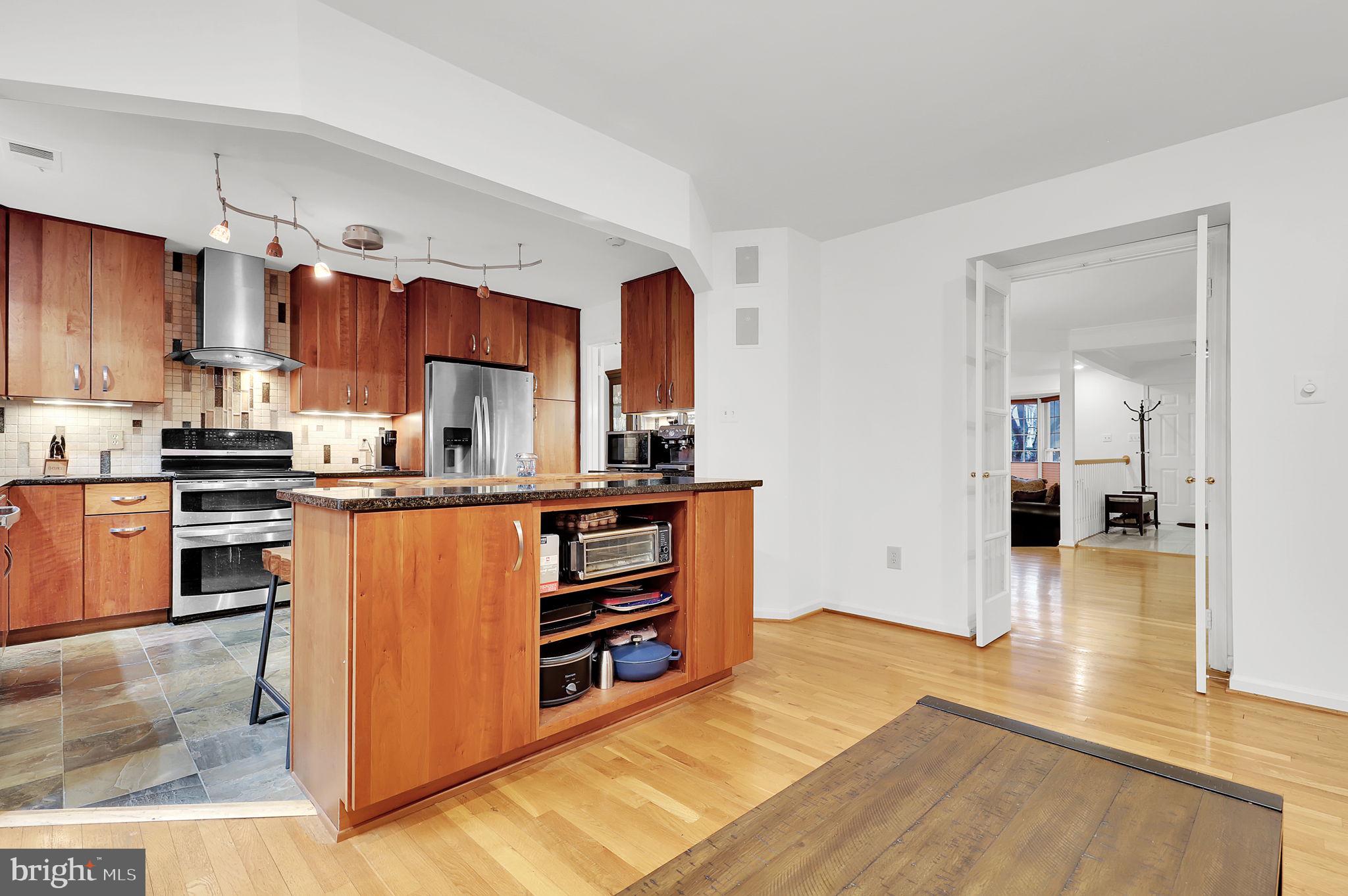 10804 Brewer House Road Rockville, MD 20852 - Photo 12 of 39 a kitchen with stainless steel appliances granite countertop a refrigerator and a stove