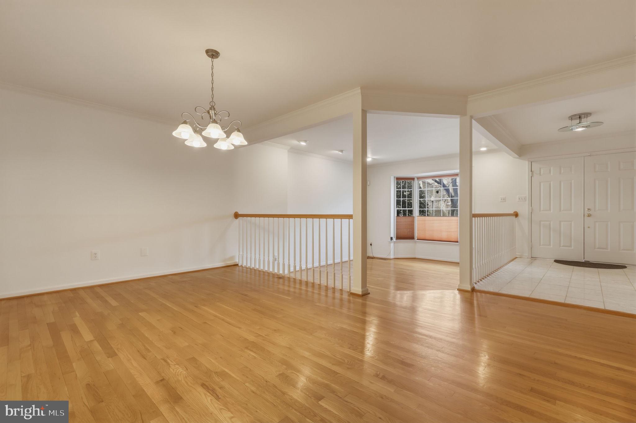 10804 Brewer House Road Rockville, MD 20852 - Photo 13 of 79 a view of a livingroom with wooden floor and chandelier