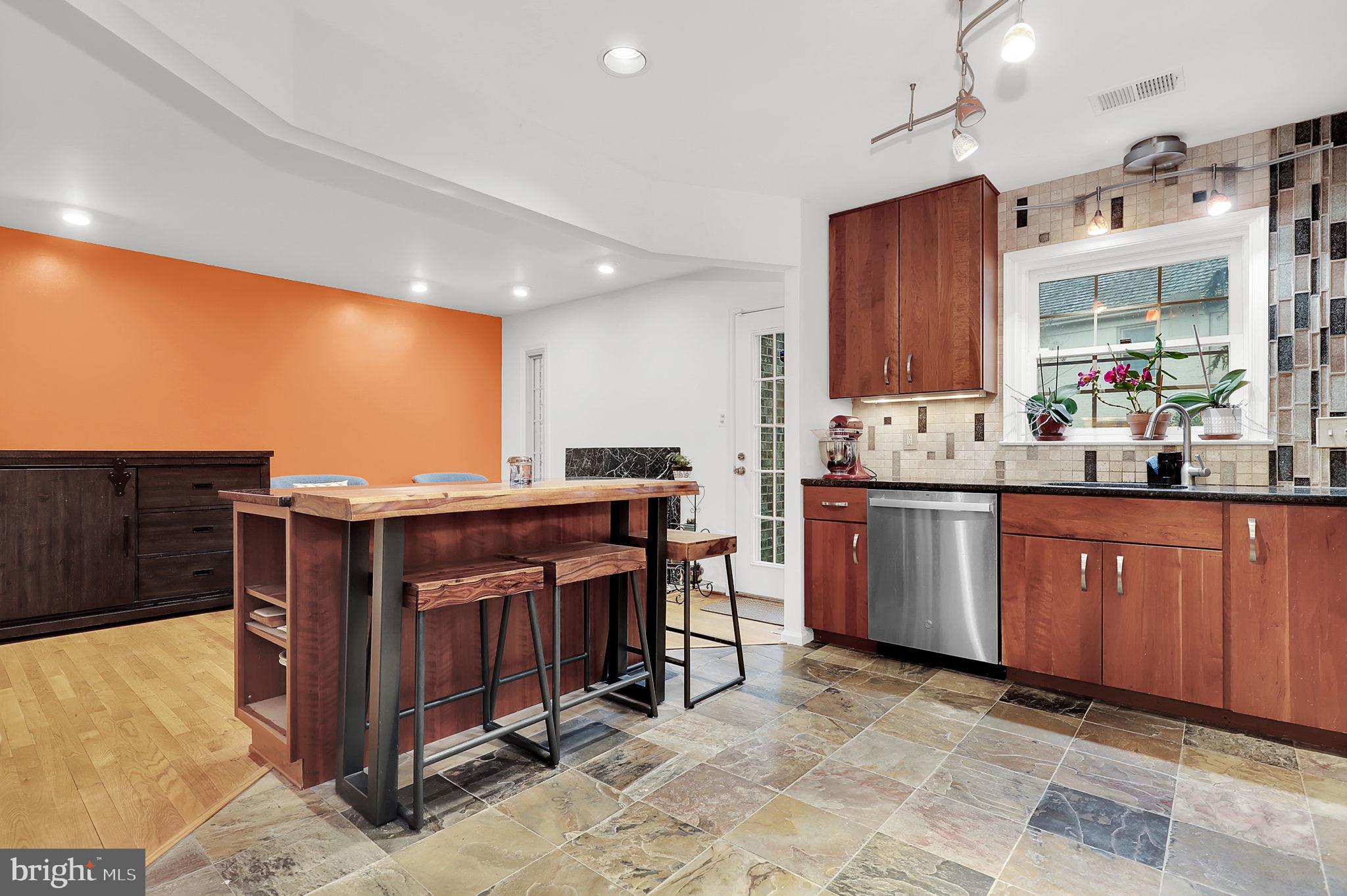 10804 Brewer House Road Rockville, MD 20852 - Photo 13 of 39 a kitchen with kitchen island granite countertop a sink cabinets and wooden floor