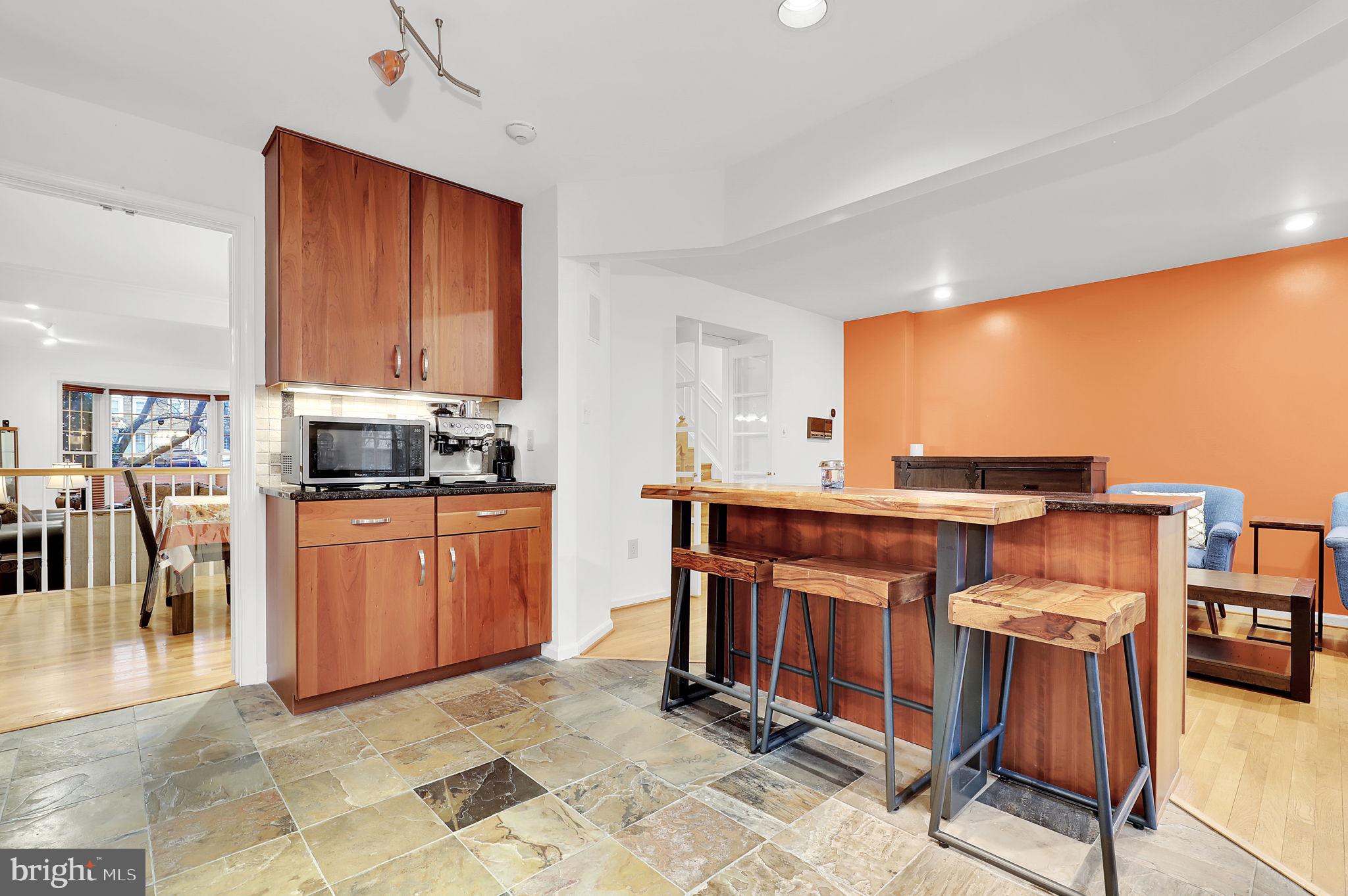 10804 Brewer House Road Rockville, MD 20852 - Photo 14 of 39 a kitchen with stainless steel appliances granite countertop a stove top oven a sink dishwasher and cabinets with wooden floor