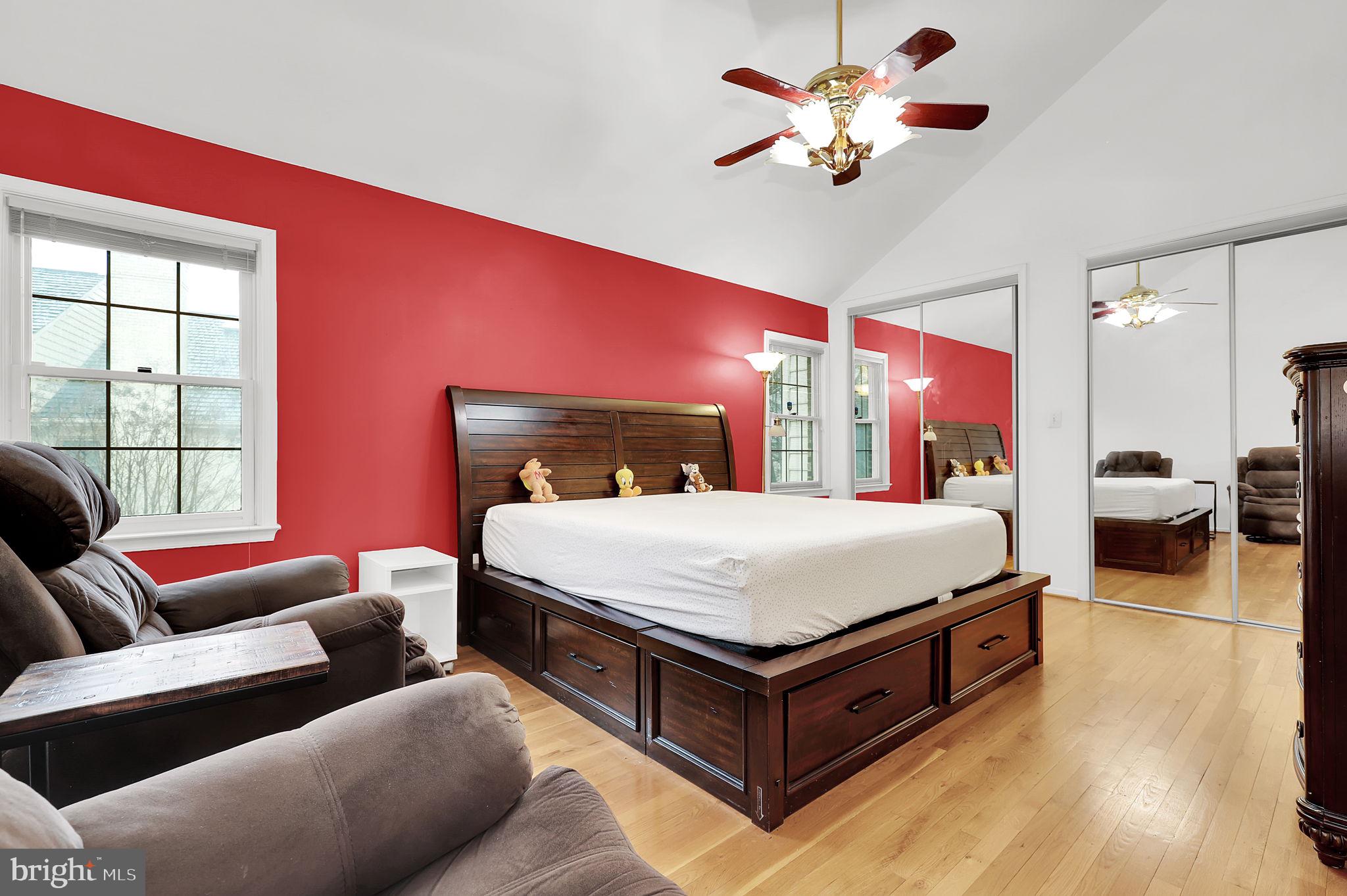 10804 Brewer House Road Rockville, MD 20852 - Photo 18 of 39 a bed room with a bed and a chandelier