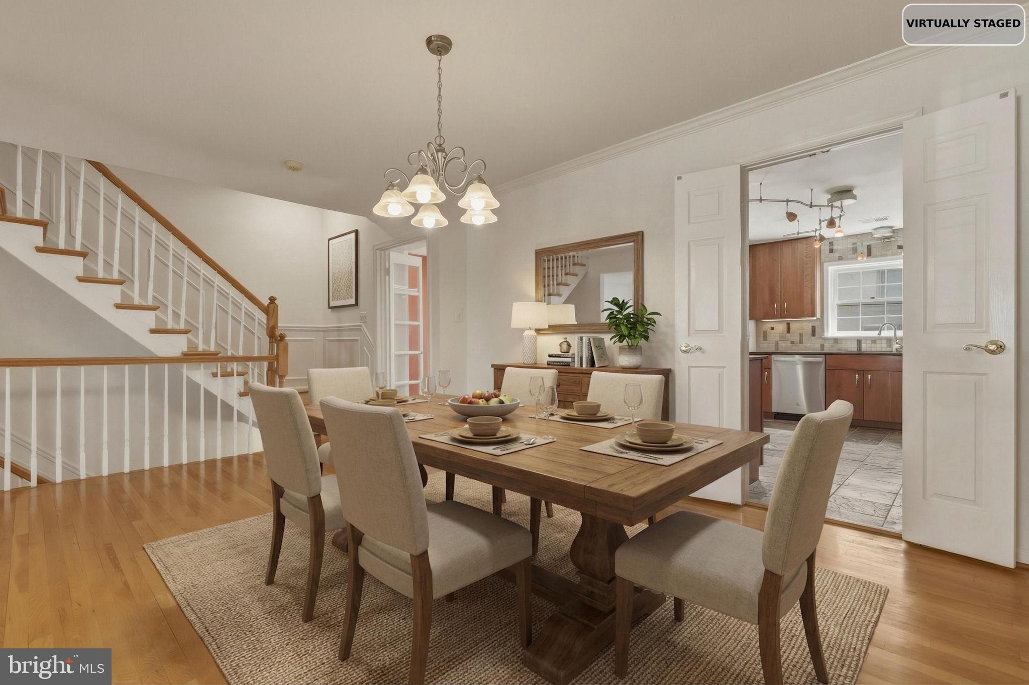 10804 Brewer House Road Rockville, MD 20852 - Photo 19 of 79 a view of a dining room with furniture a chandelier and wooden floor