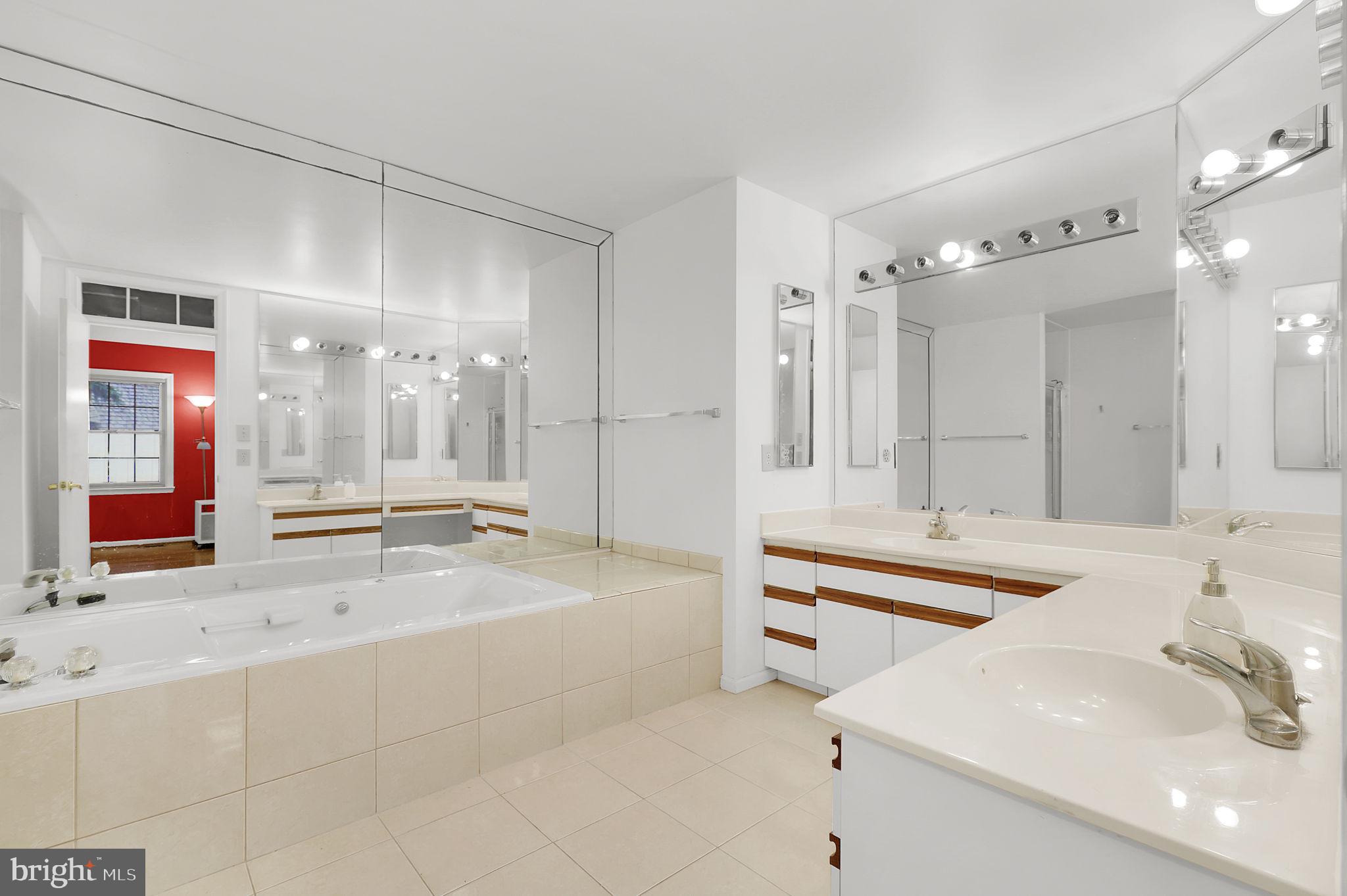 10804 Brewer House Road Rockville, MD 20852 - Photo 21 of 39 a large bathroom with a tub sink shower and mirror