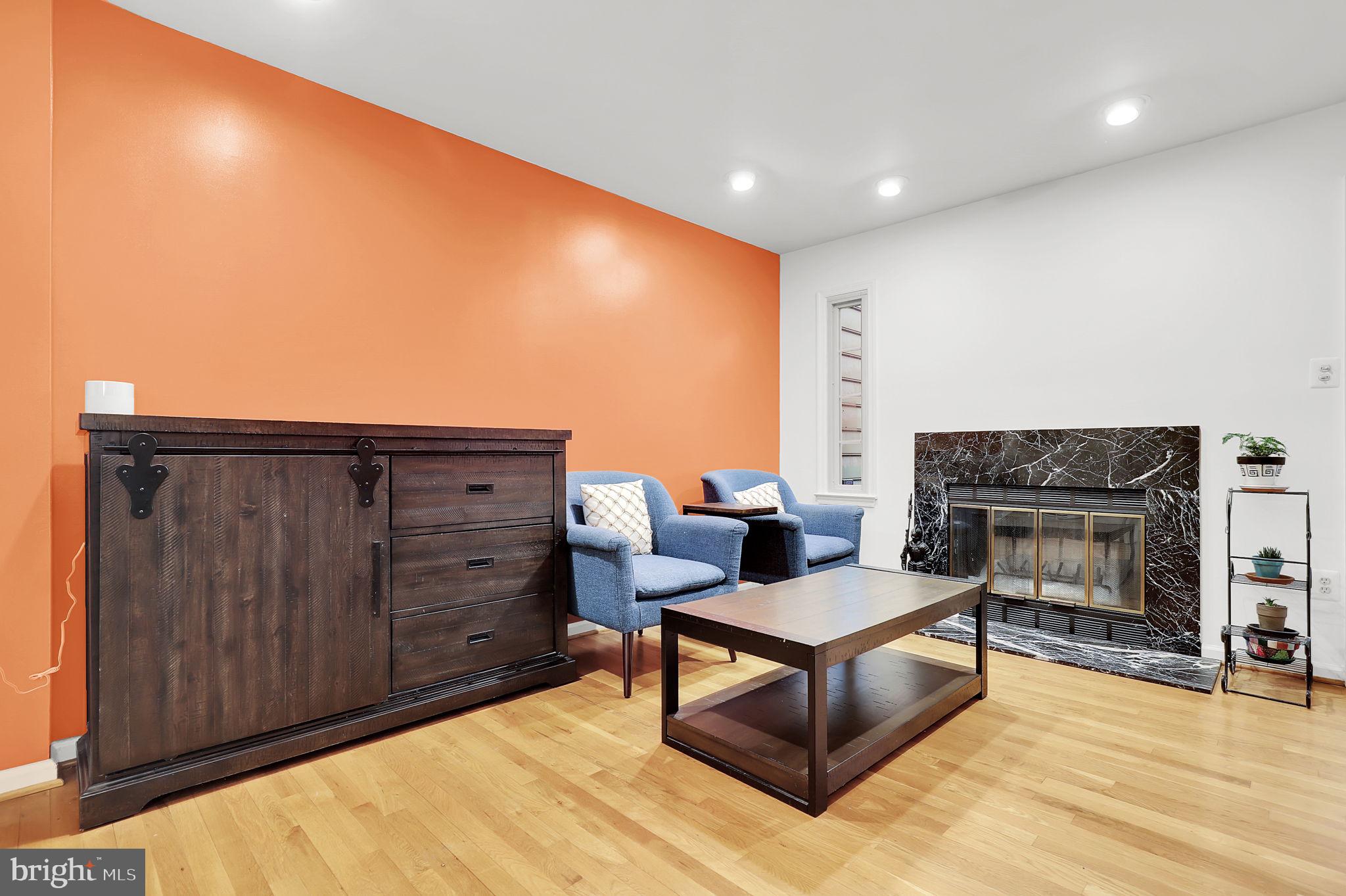 10804 Brewer House Road Rockville, MD 20852 - Photo 21 of 79 a living room with furniture a fireplace and a flat screen tv