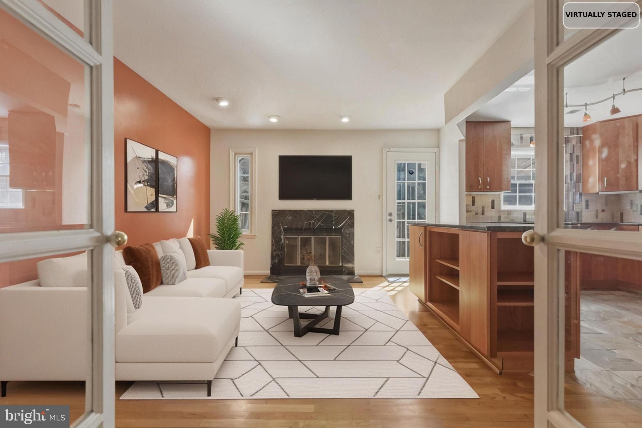10804 Brewer House Road Rockville, MD 20852 - Photo 24 of 79 a living room with furniture a fireplace and a flat screen tv