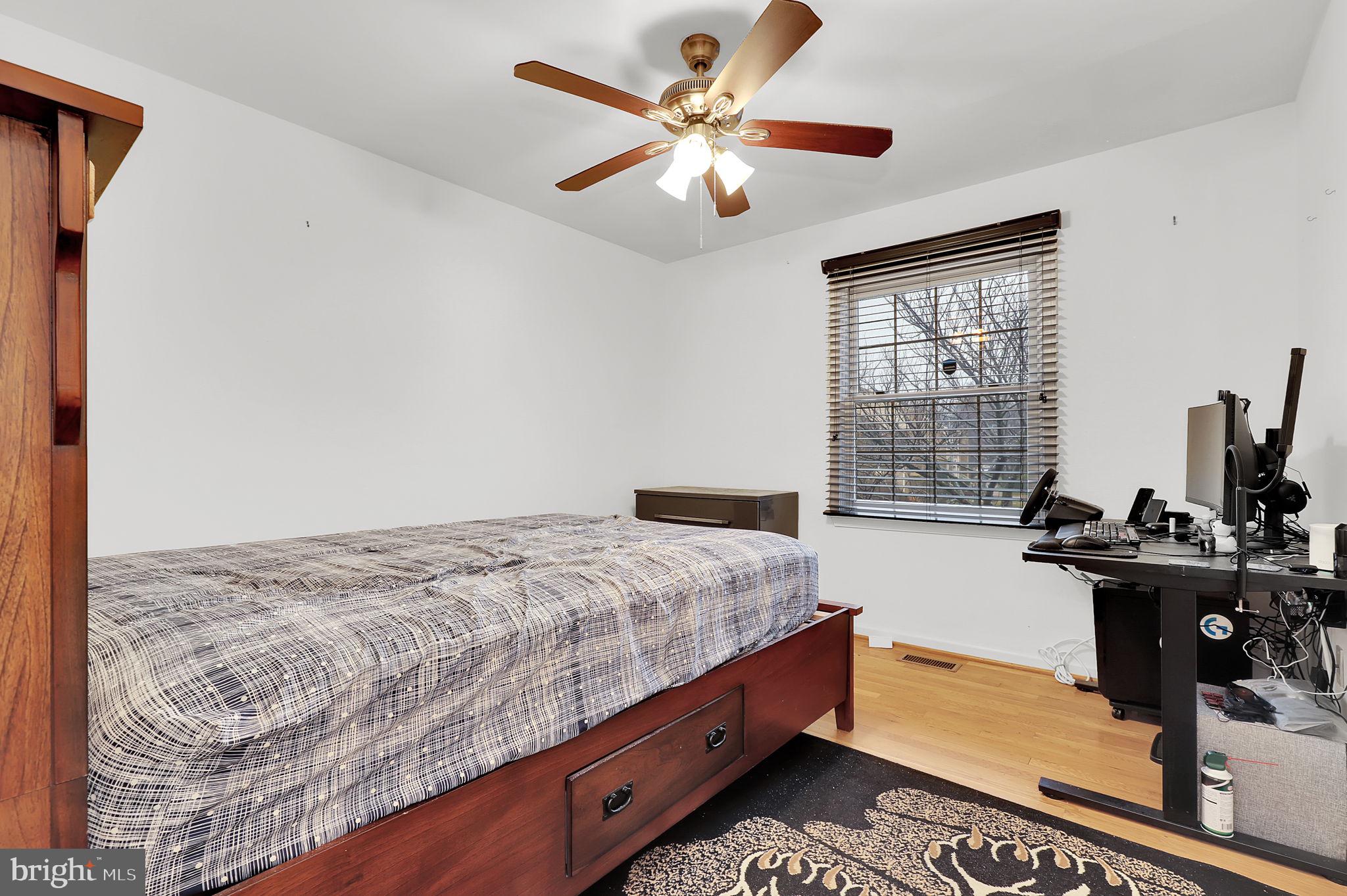 10804 Brewer House Road Rockville, MD 20852 - Photo 29 of 39 a bedroom with bed and a window