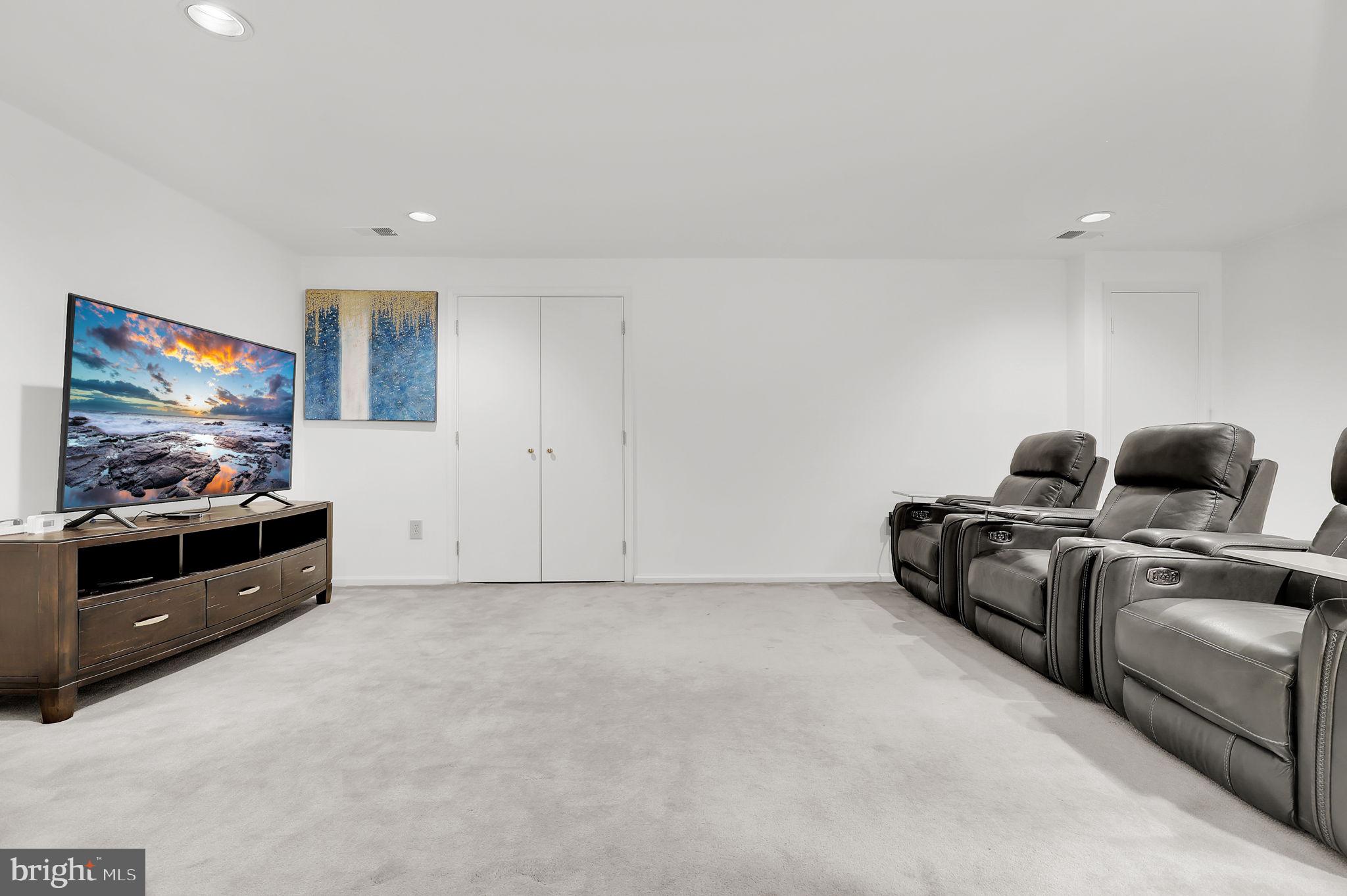 10804 Brewer House Road Rockville, MD 20852 - Photo 30 of 39 a living room with furniture and a flat screen tv