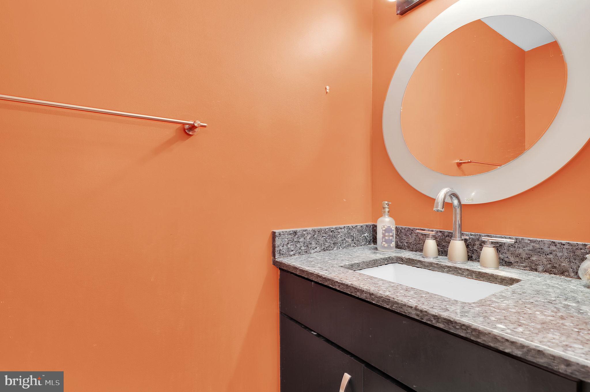 10804 Brewer House Road Rockville, MD 20852 - Photo 31 of 79 a bathroom with a granite countertop sink and a mirror