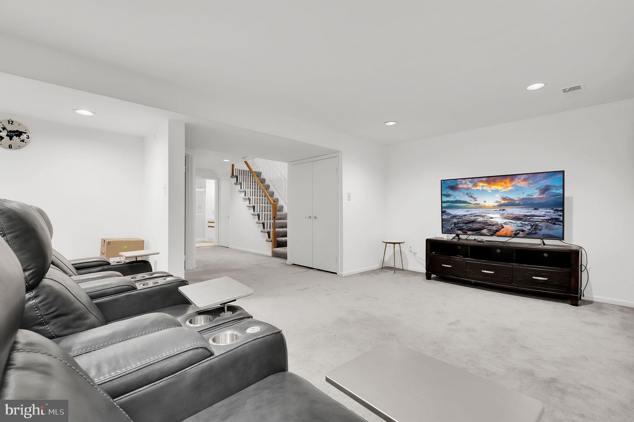 10804 Brewer House Road Rockville, MD 20852 - Photo 32 of 39 a living room with furniture and a flat screen tv