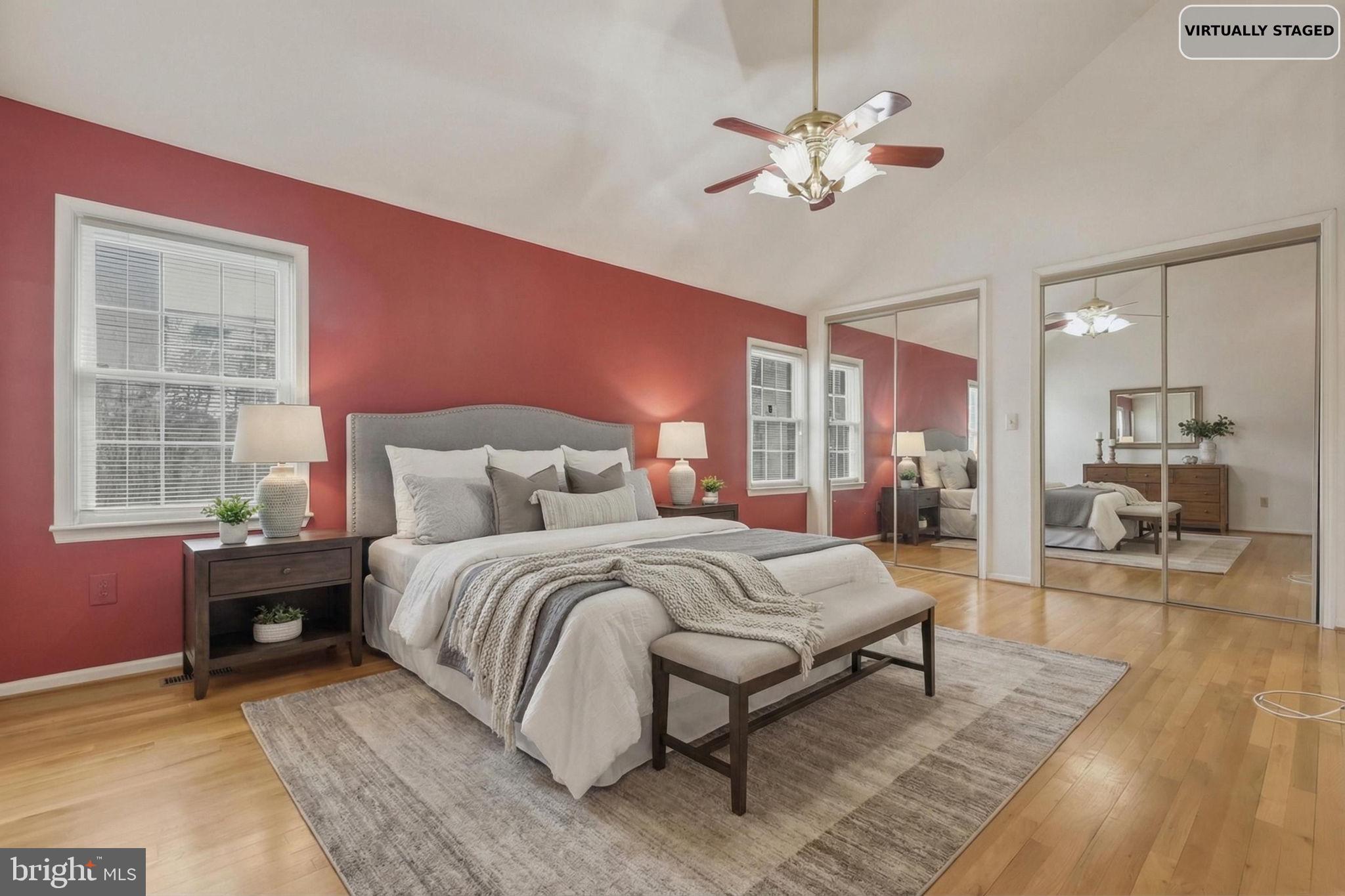 10804 Brewer House Road Rockville, MD 20852 - Photo 41 of 79 a spacious bedroom with a large bed a chandelier and windows
