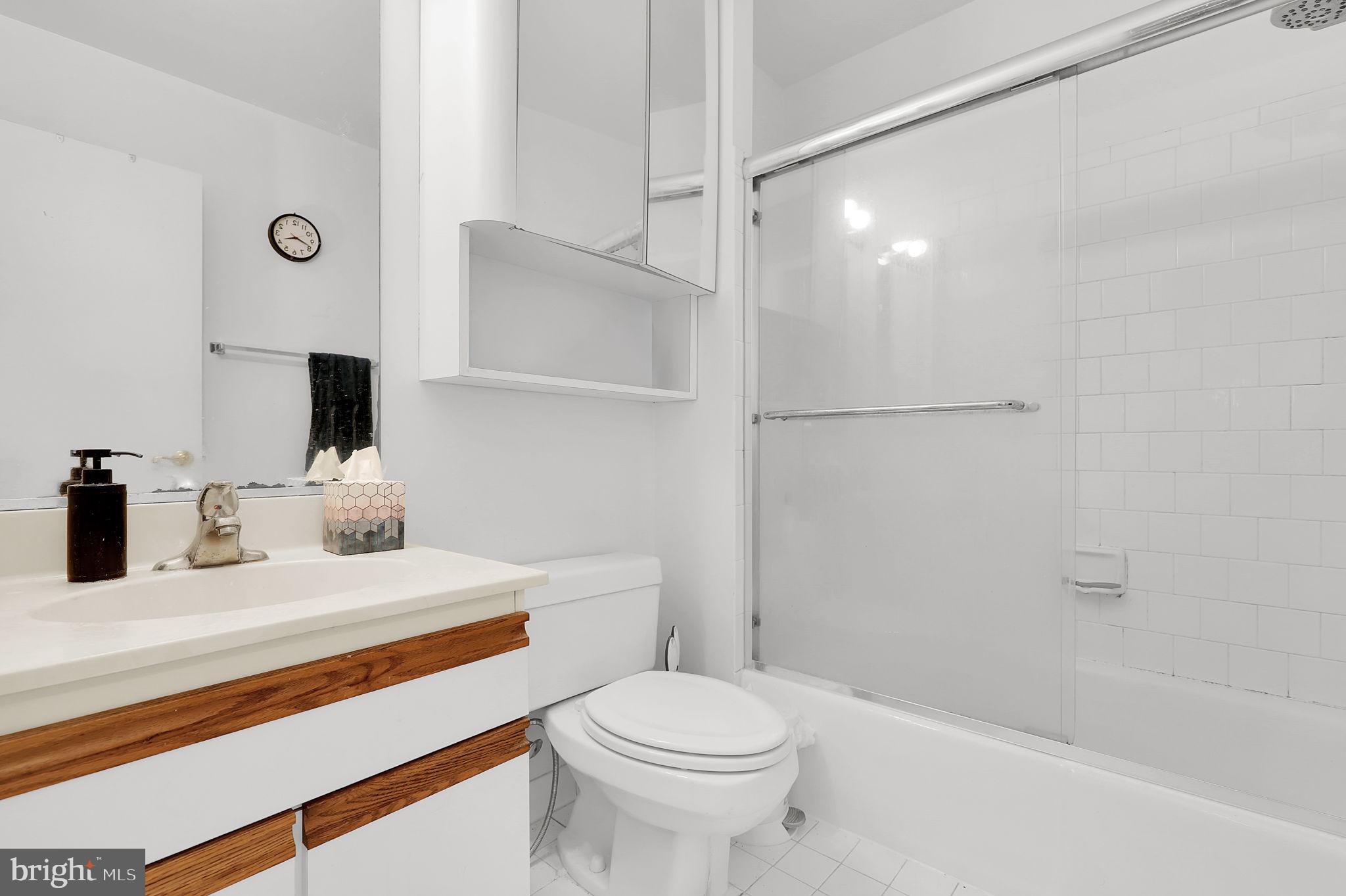 10804 Brewer House Road Rockville, MD 20852 - Photo 47 of 79 a bathroom with a sink toilet vanity and shower