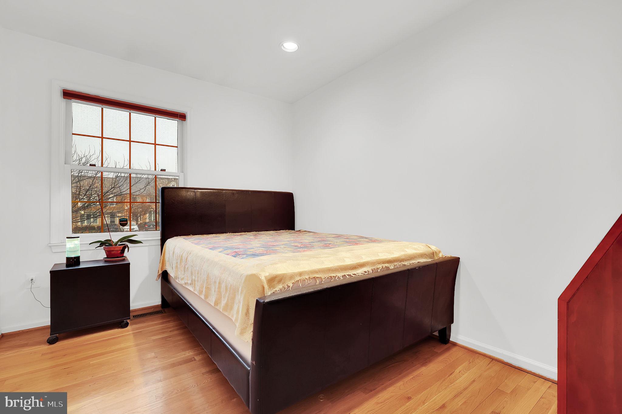 10804 Brewer House Road Rockville, MD 20852 - Photo 49 of 79 a bedroom with a bed and window