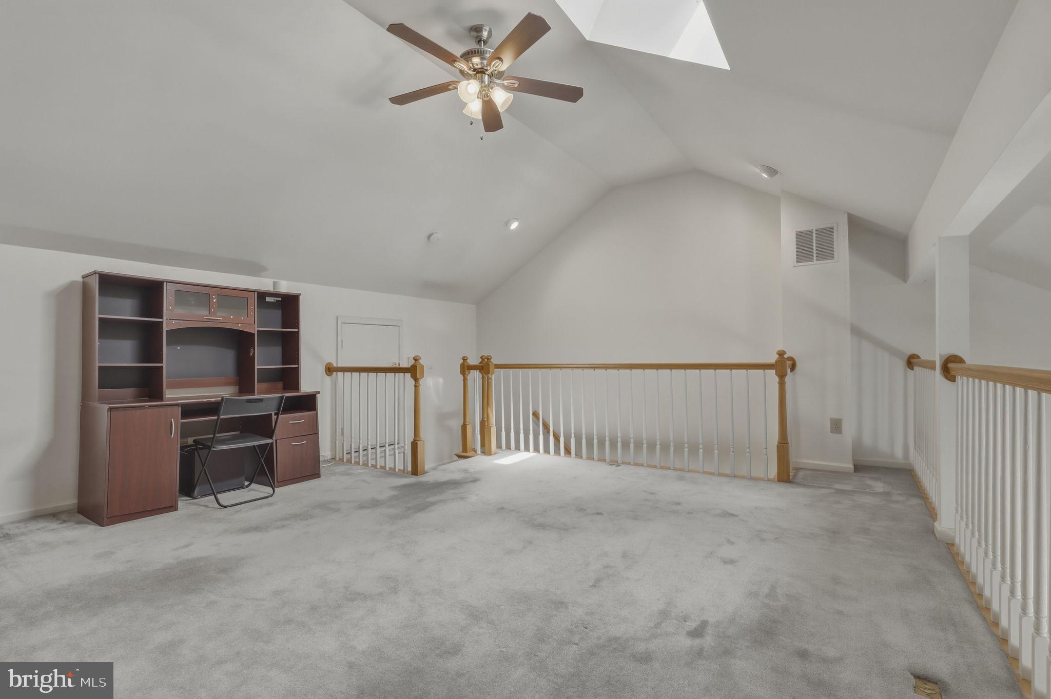 10804 Brewer House Road Rockville, MD 20852 - Photo 58 of 79 a view of a livingroom with a ceiling fan & kitchen space