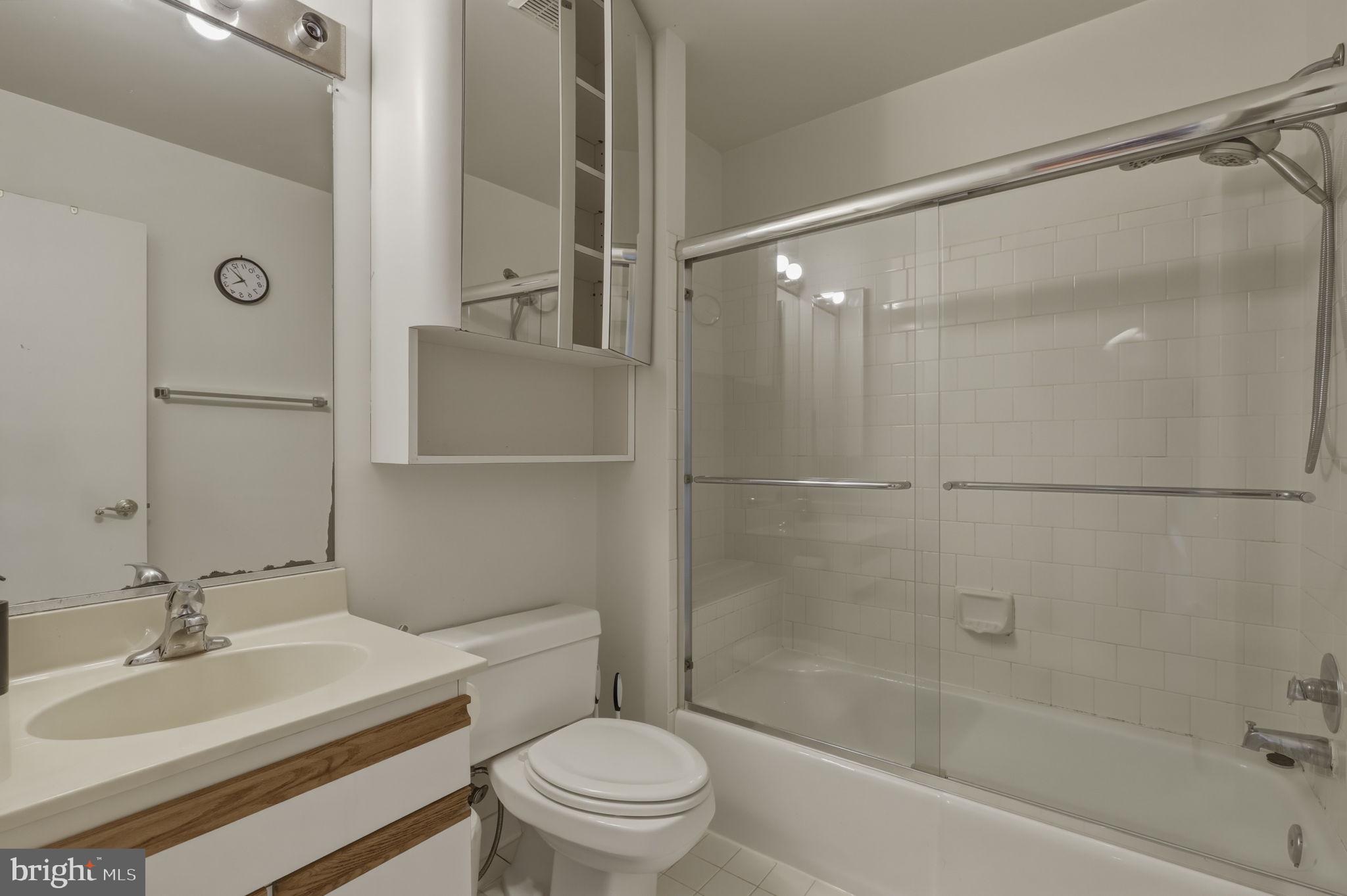 10804 Brewer House Road Rockville, MD 20852 - Photo 60 of 79 a bathroom with a bathtub shower sink vanity and toilet