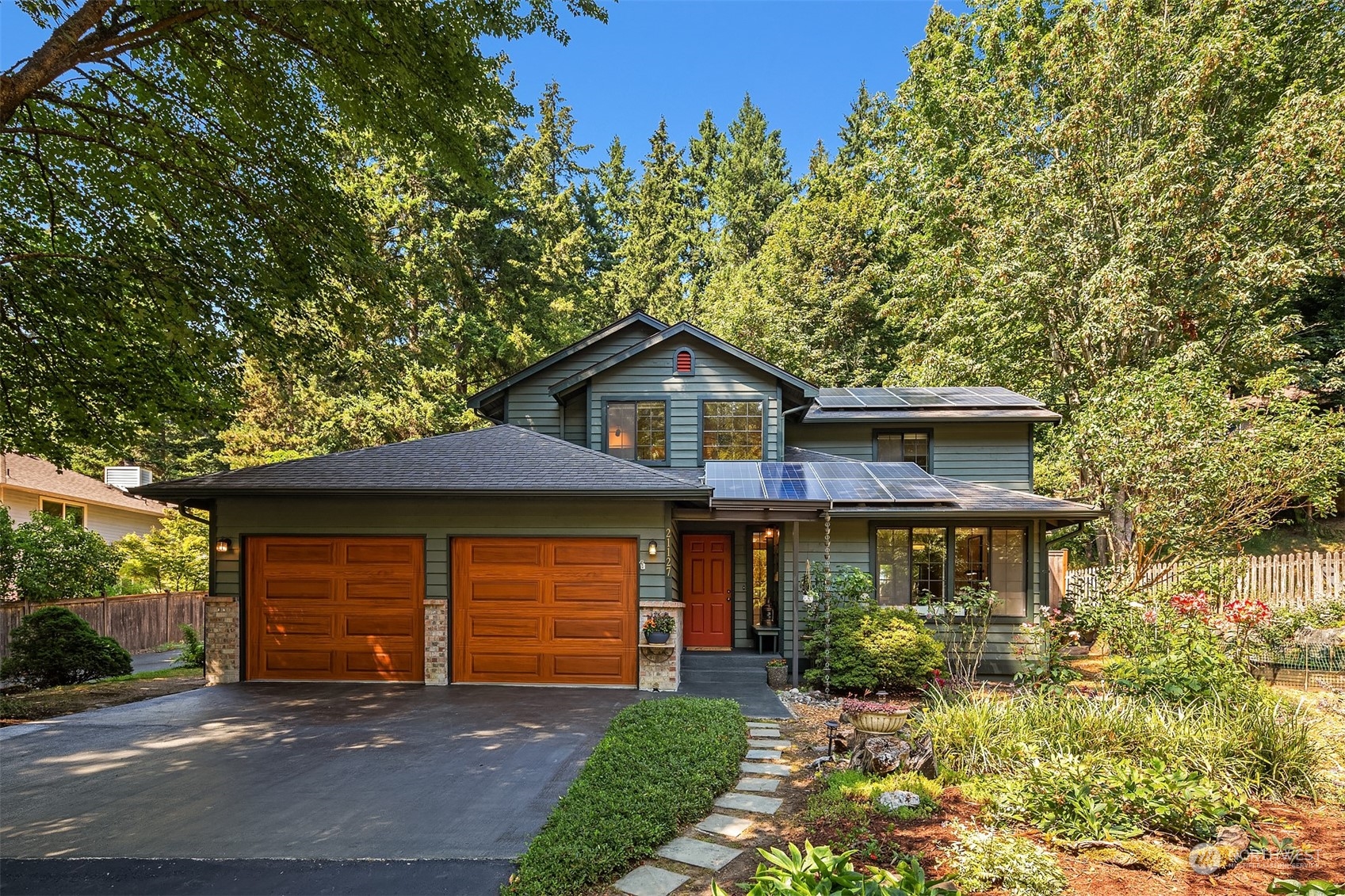a front view of a house with a yard and garage