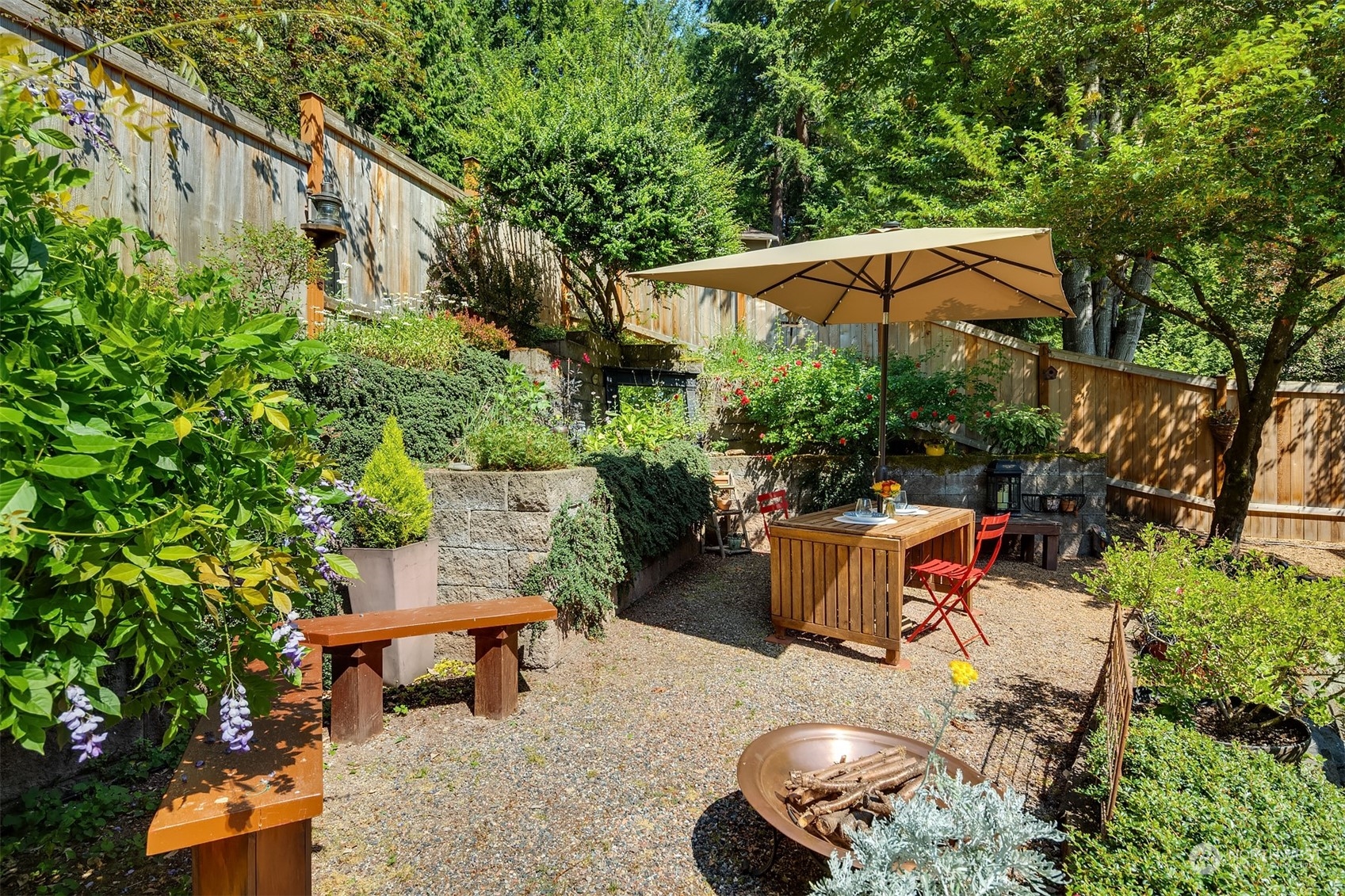 21127 Shell Valley Road Edmonds, WA 98026 - Photo 30 of 40 a backyard of a house with table and chairs under an umbrella