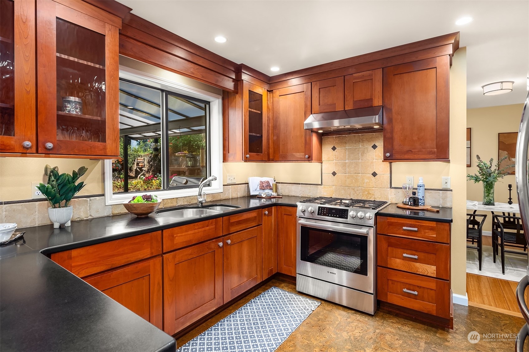 21127 Shell Valley Road Edmonds, WA 98026 - Photo 8 of 40 a kitchen with stainless steel appliances granite countertop a sink stove and refrigerator