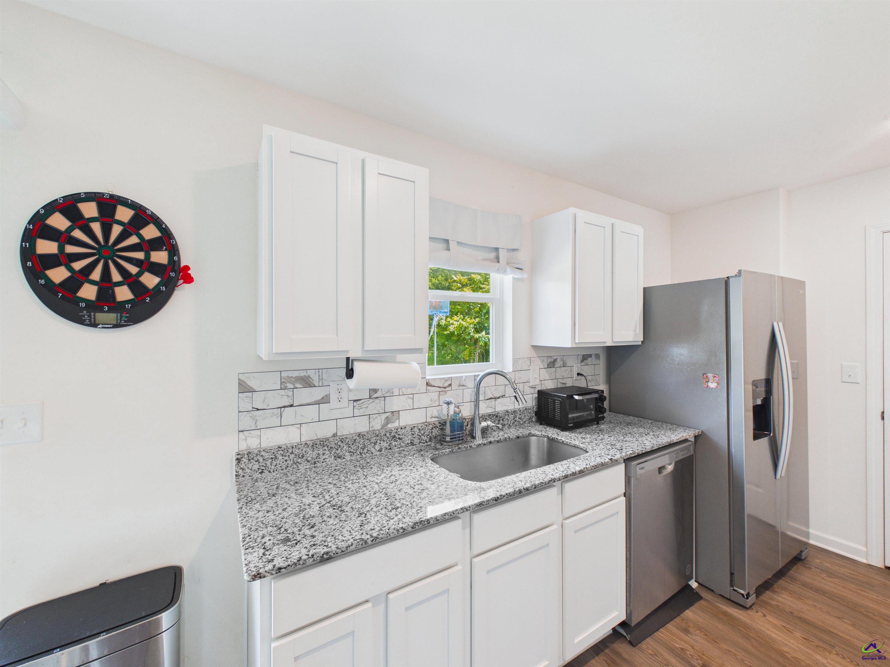 116 Jamie Court Fort Valley, GA 31030 - Photo 5 of 19 a kitchen with stainless steel appliances granite countertop a sink and a refrigerator