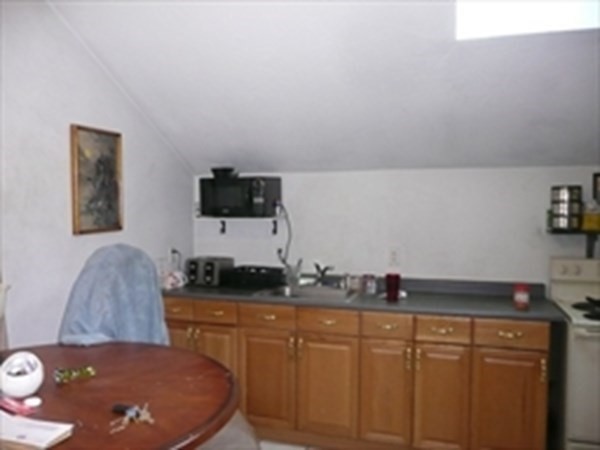 1 Lawrence Road Revere, MA 02151 - Photo 4 of 15 a kitchen with stainless steel appliances a stove a sink and a refrigerator
