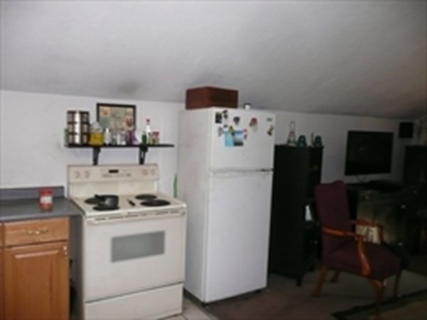 1 Lawrence Road Revere, MA 02151 - Photo 5 of 15 a kitchen with stainless steel appliances a refrigerator stove and white cabinets