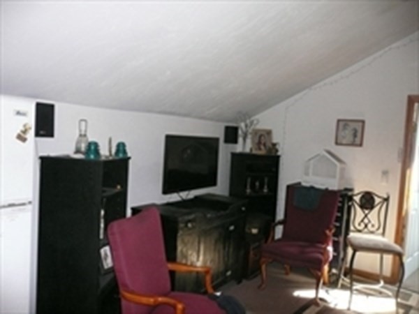 1 Lawrence Road Revere, MA 02151 - Photo 8 of 15 a living room with furniture a flat screen tv and a fireplace