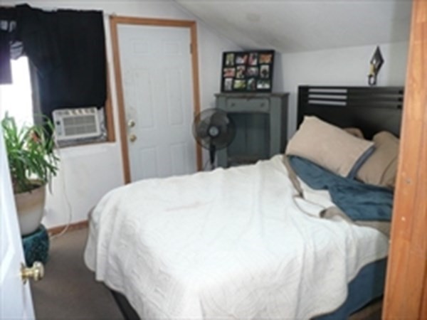 1 Lawrence Road Revere, MA 02151 - Photo 10 of 15 a bedroom with a bed and a potted plant