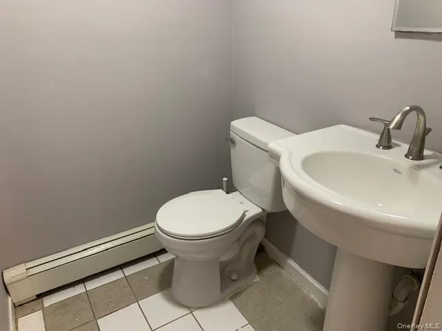 a white toilet sitting next to a white sink