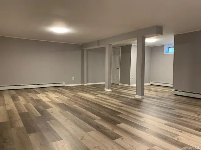 a view of a room with wooden floor