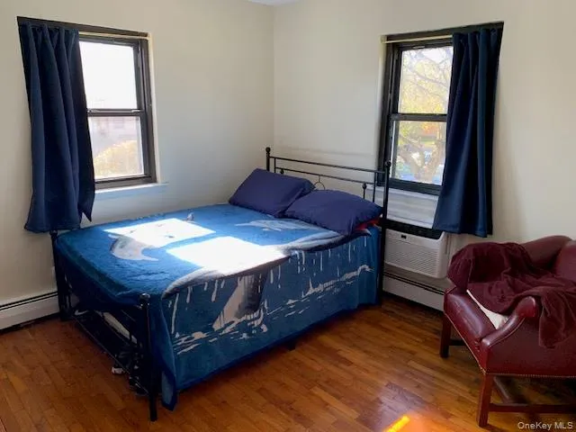 a bedroom with a bed chair and a window