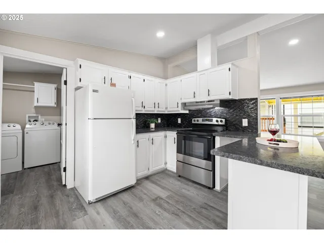 a kitchen with white cabinets and white appliances