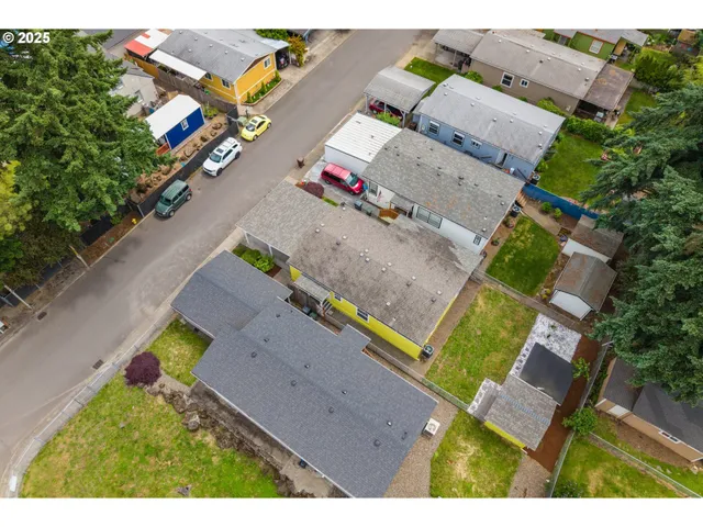 an aerial view of a house with a garden and swimming pool