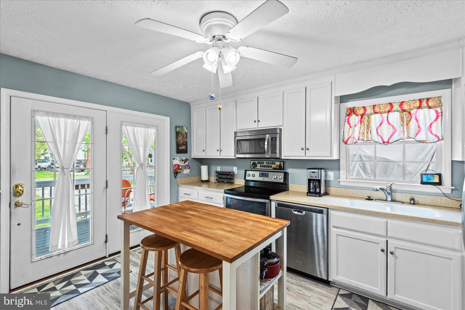 720 Bancroft Avenue Colonial Beach, VA 22443 - Photo 12 of 59 a kitchen with kitchen island granite countertop a sink appliances counter top space and cabinets