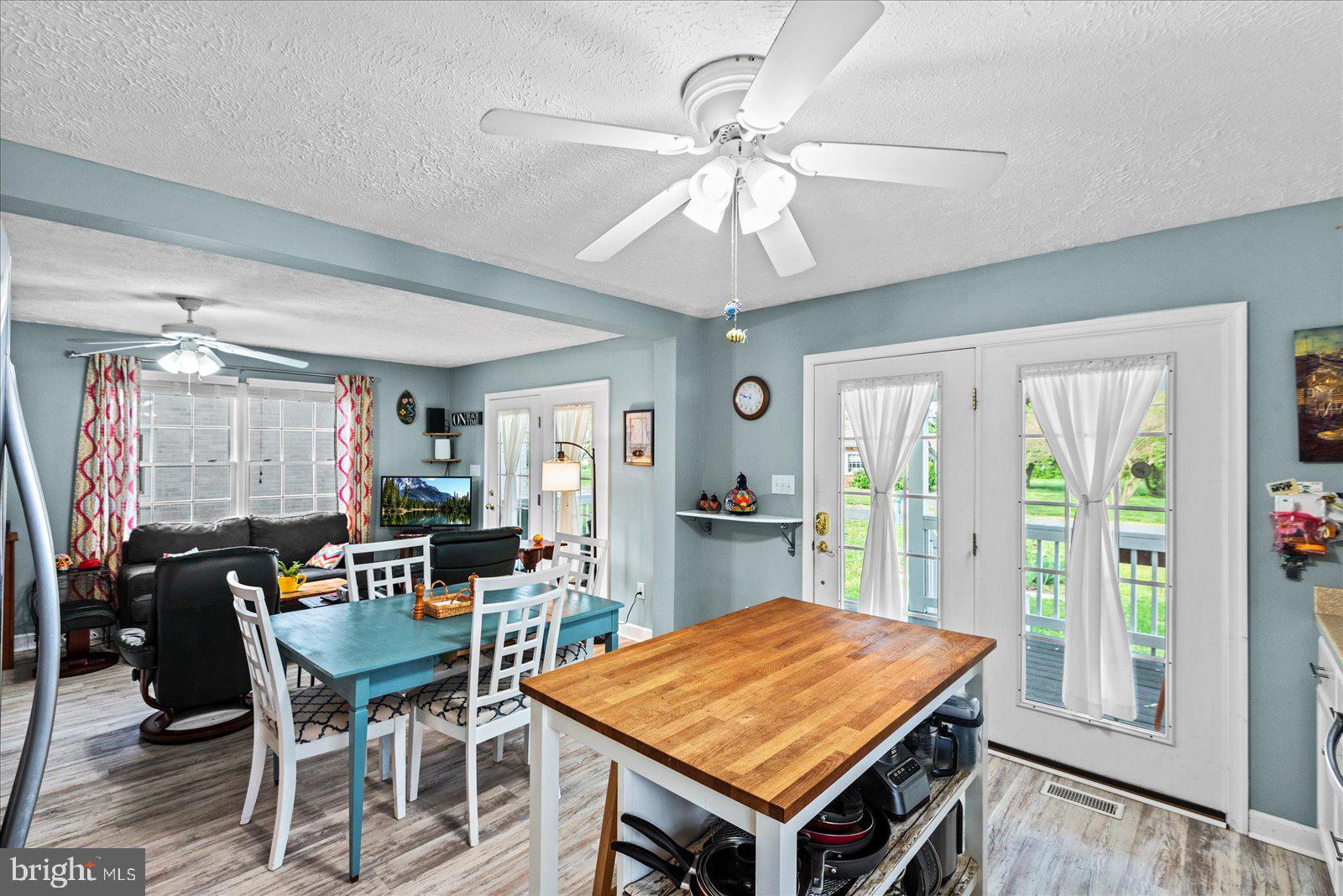 720 Bancroft Avenue Colonial Beach, VA 22443 - Photo 13 of 59 a view of a dining room with furniture window and wooden floor