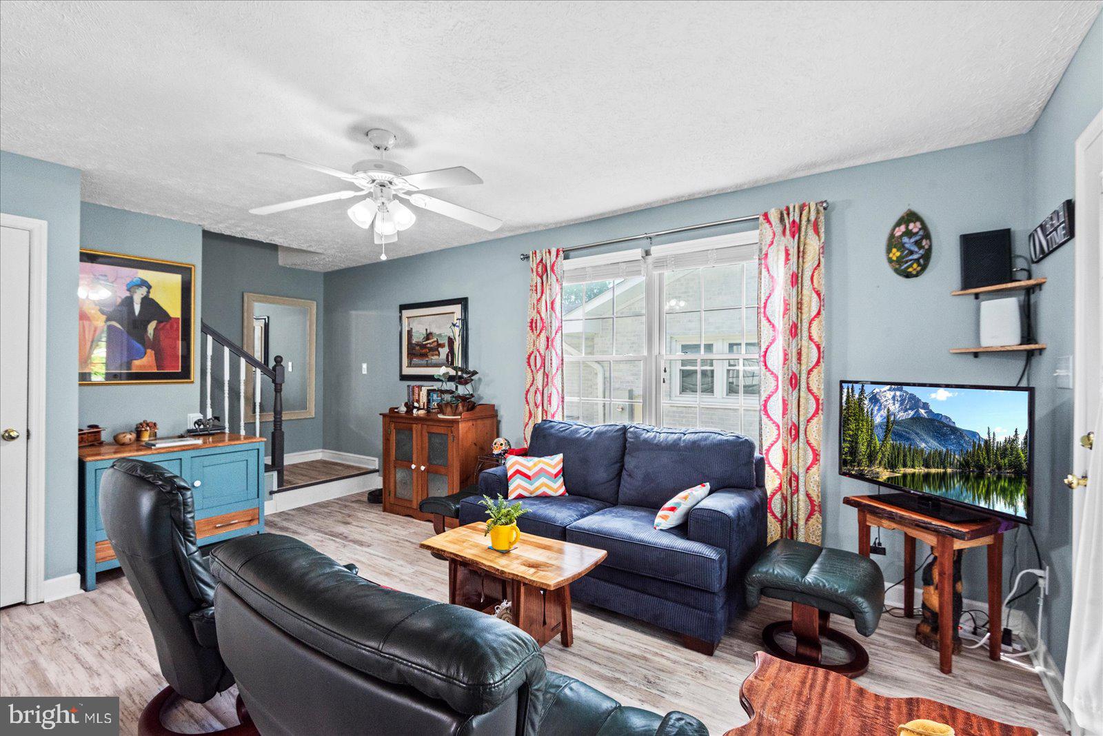 720 Bancroft Avenue Colonial Beach, VA 22443 - Photo 16 of 59 a living room with furniture a flat screen tv and a window