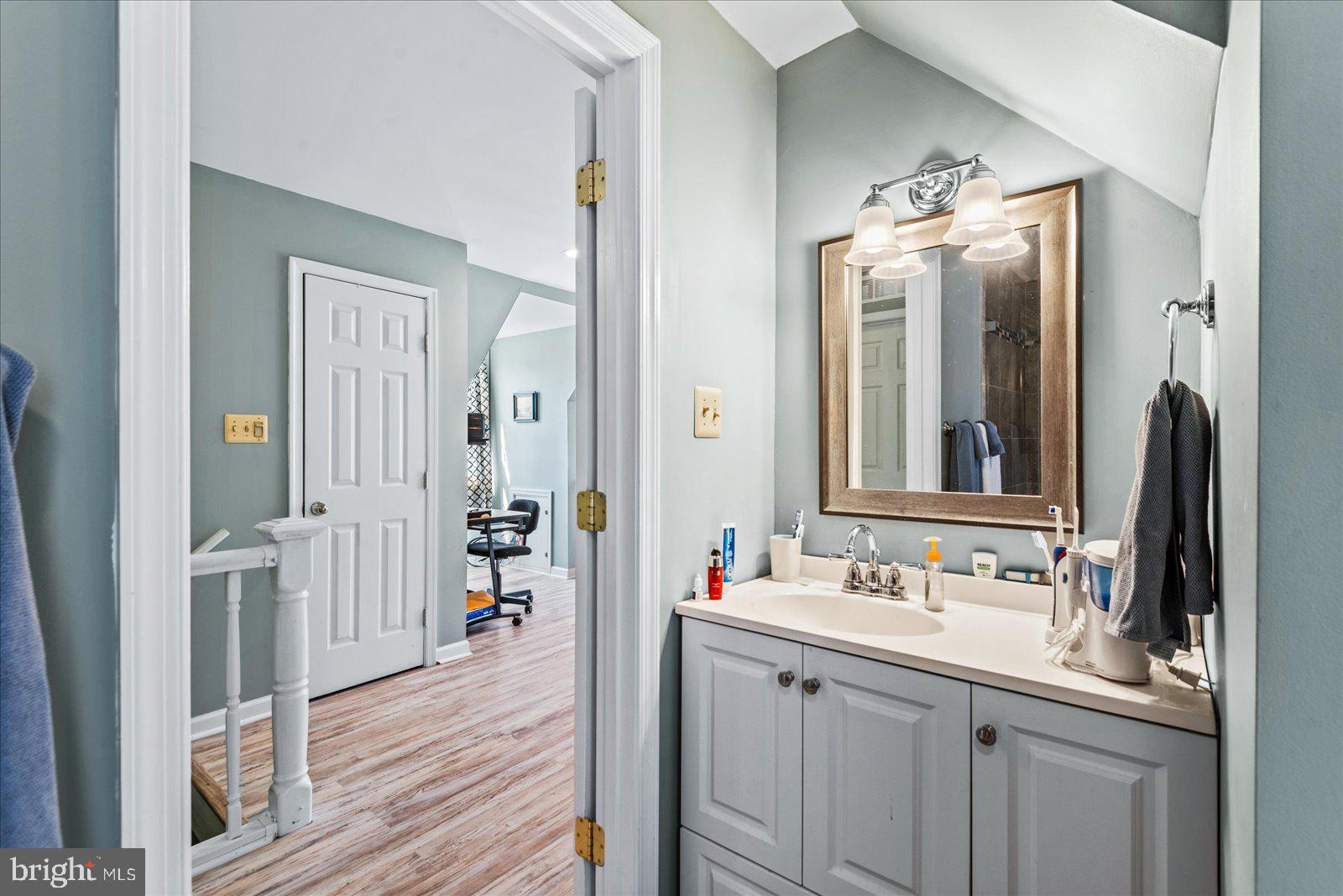 720 Bancroft Avenue Colonial Beach, VA 22443 - Photo 30 of 59 a bathroom with a double vanity sink and a mirror