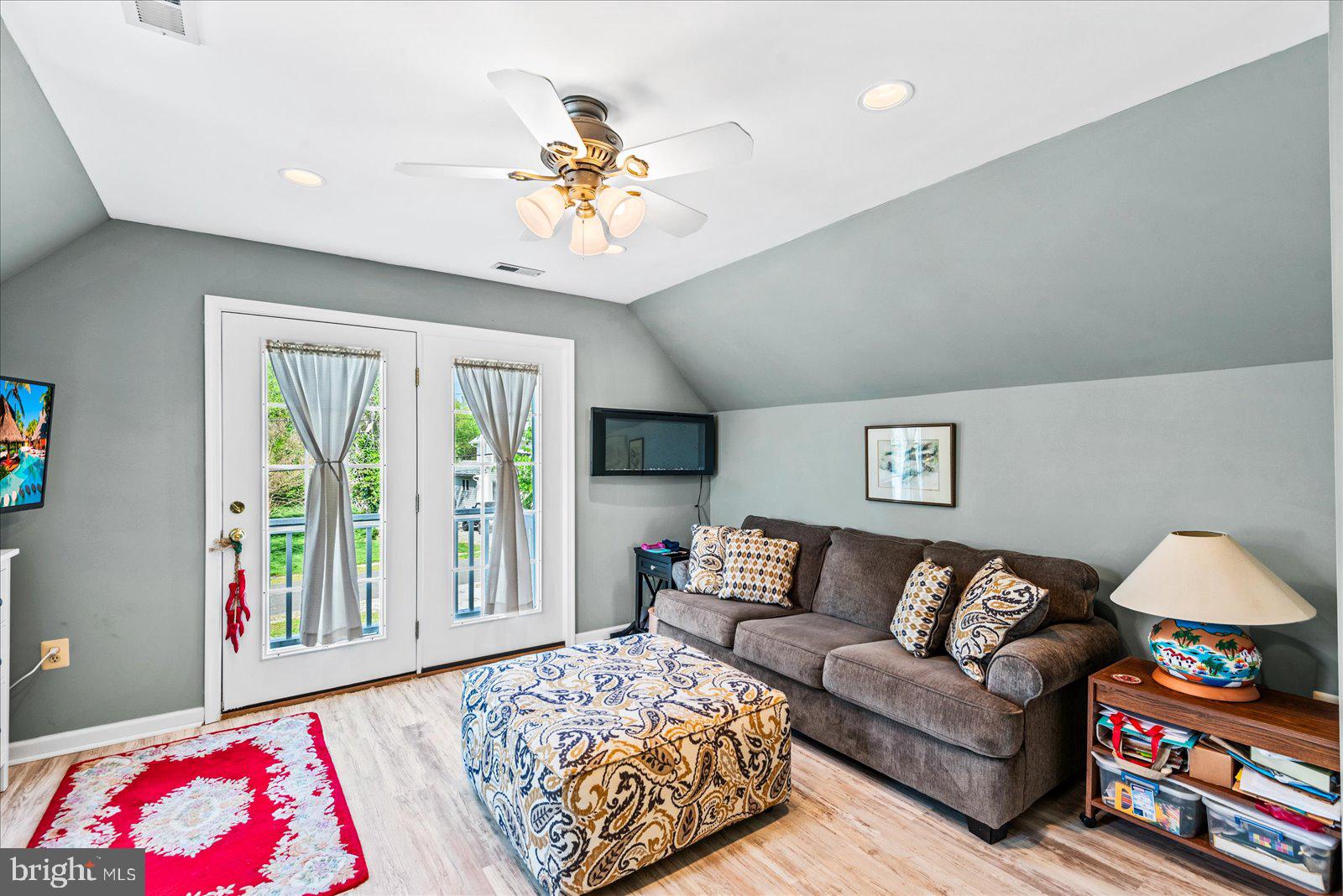 720 Bancroft Avenue Colonial Beach, VA 22443 - Photo 33 of 59 a bedroom with a bed and a chandelier