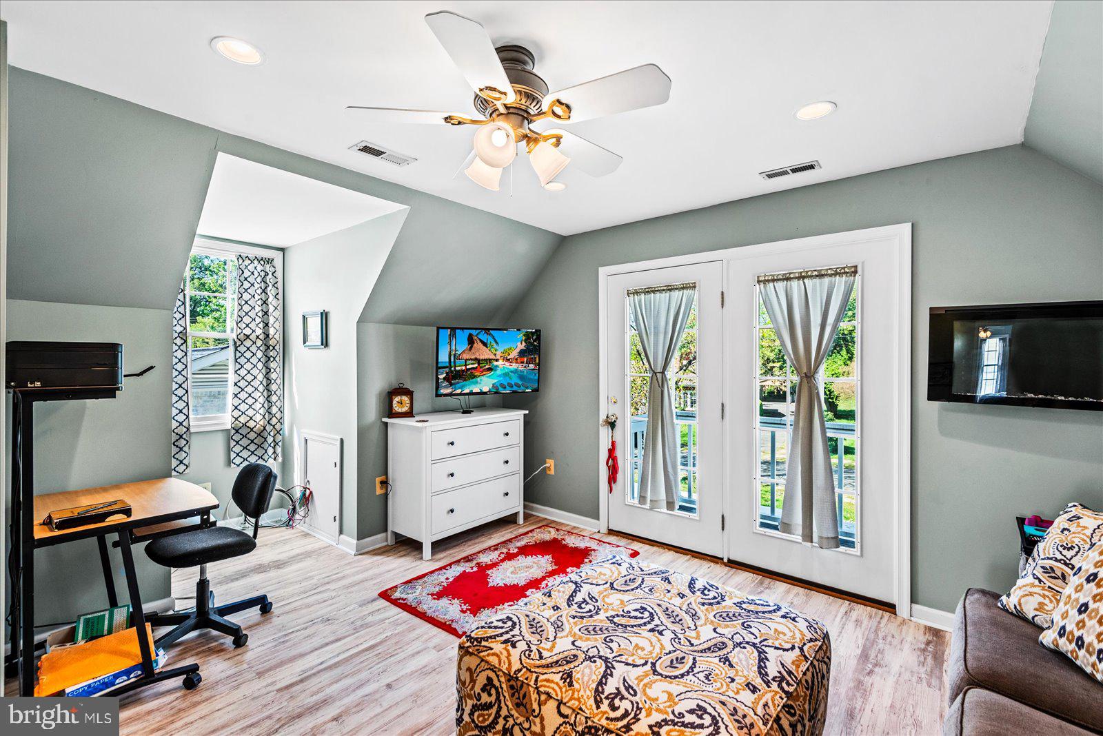 720 Bancroft Avenue Colonial Beach, VA 22443 - Photo 34 of 59 a bedroom with a bed and a chandelier