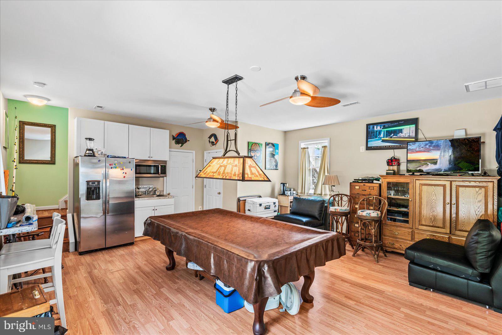 720 Bancroft Avenue Colonial Beach, VA 22443 - Photo 39 of 59 a living room with stainless steel appliances furniture a rug and a kitchen view