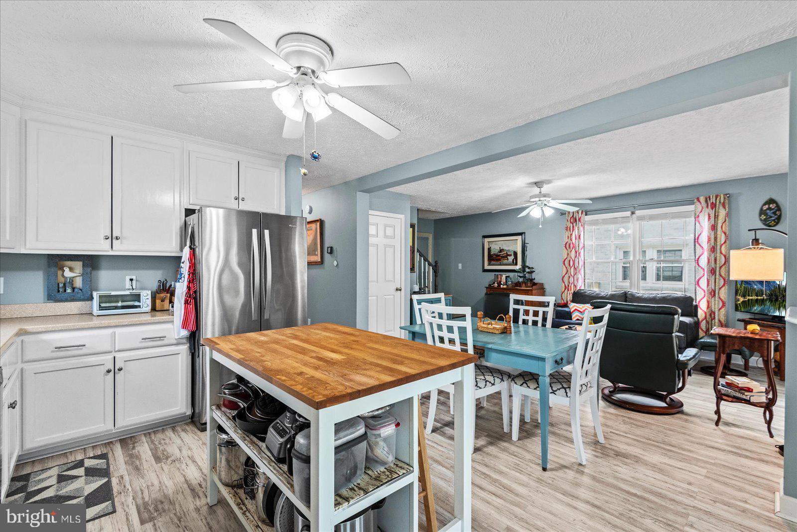 720 Bancroft Avenue Colonial Beach, VA 22443 - Photo 10 of 59 a kitchen with stainless steel appliances a stove a refrigerator and a dining table