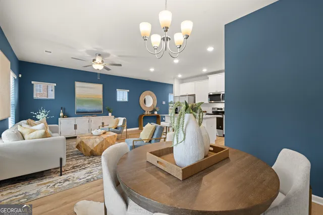 a living room with fireplace furniture and a chandelier