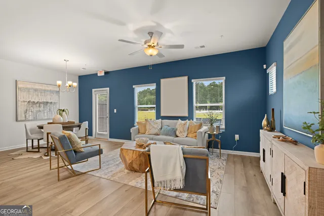 a living room with furniture and a chandelier
