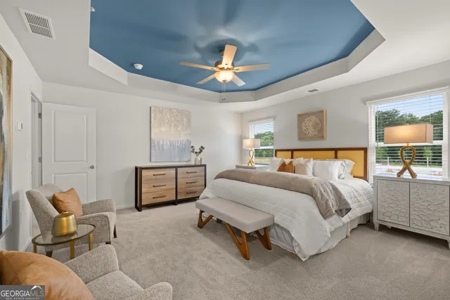 a bedroom with a bed and a chandelier