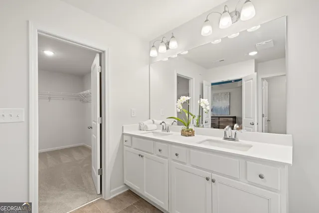 a bathroom with a double vanity sink and a mirror