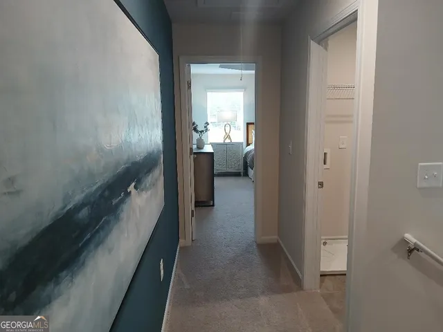 a view of a hallway with wooden floor and entryway