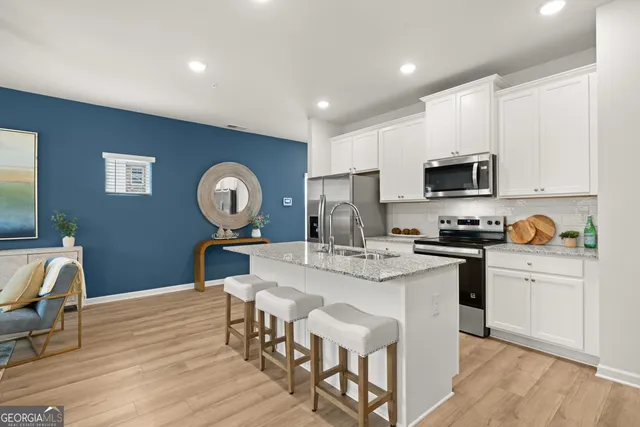 a view of kitchen with sink dining table and chairs