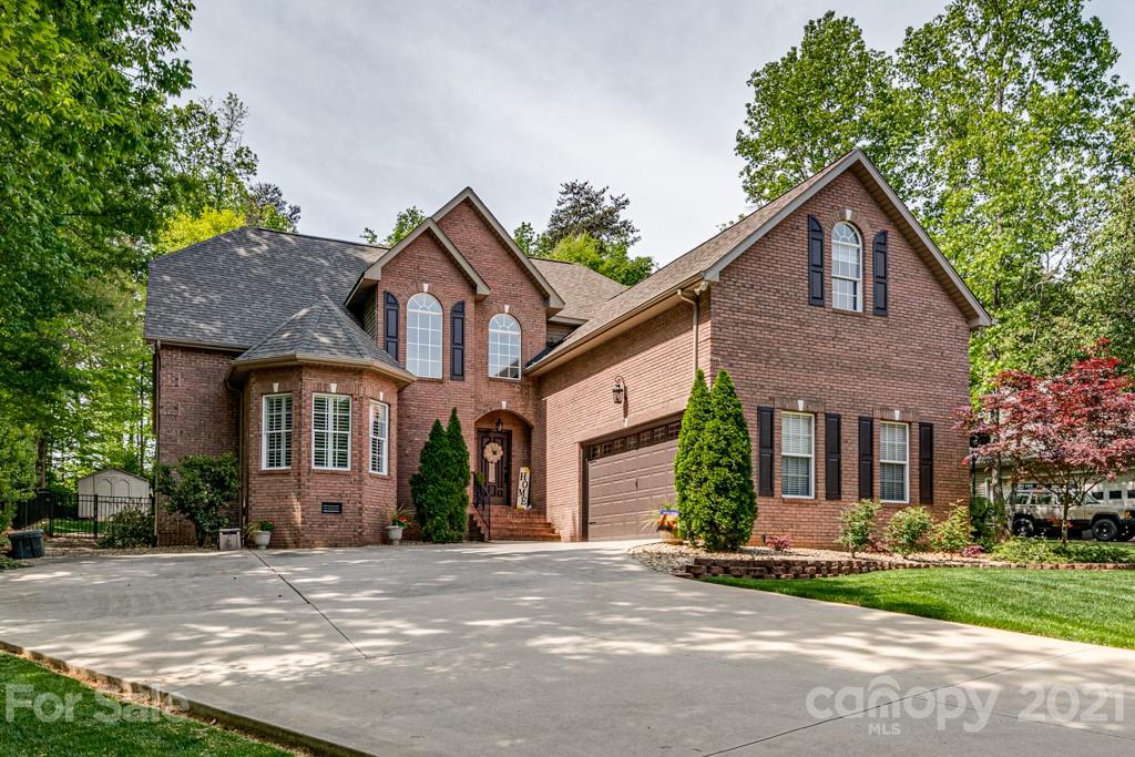 4367 Lake Shore Road North Denver, NC 28037 - Photo 2 of 48 a front view of a house with a yard and garage