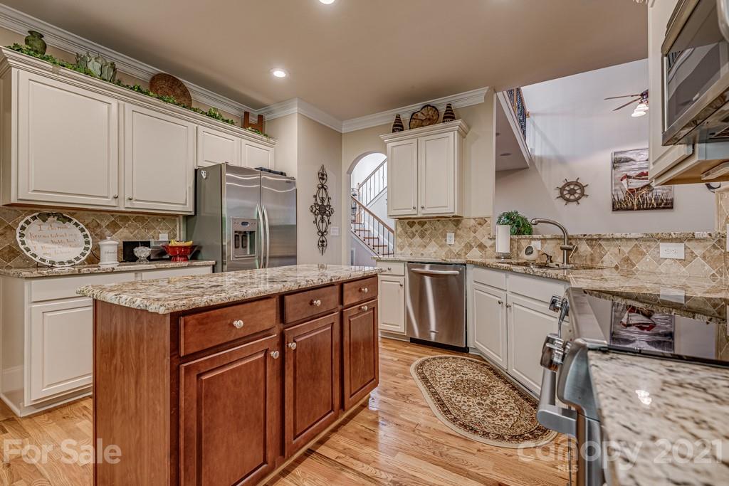 4367 Lake Shore Road North Denver, NC 28037 - Photo 13 of 48 a kitchen with granite countertop a sink stove and cabinets