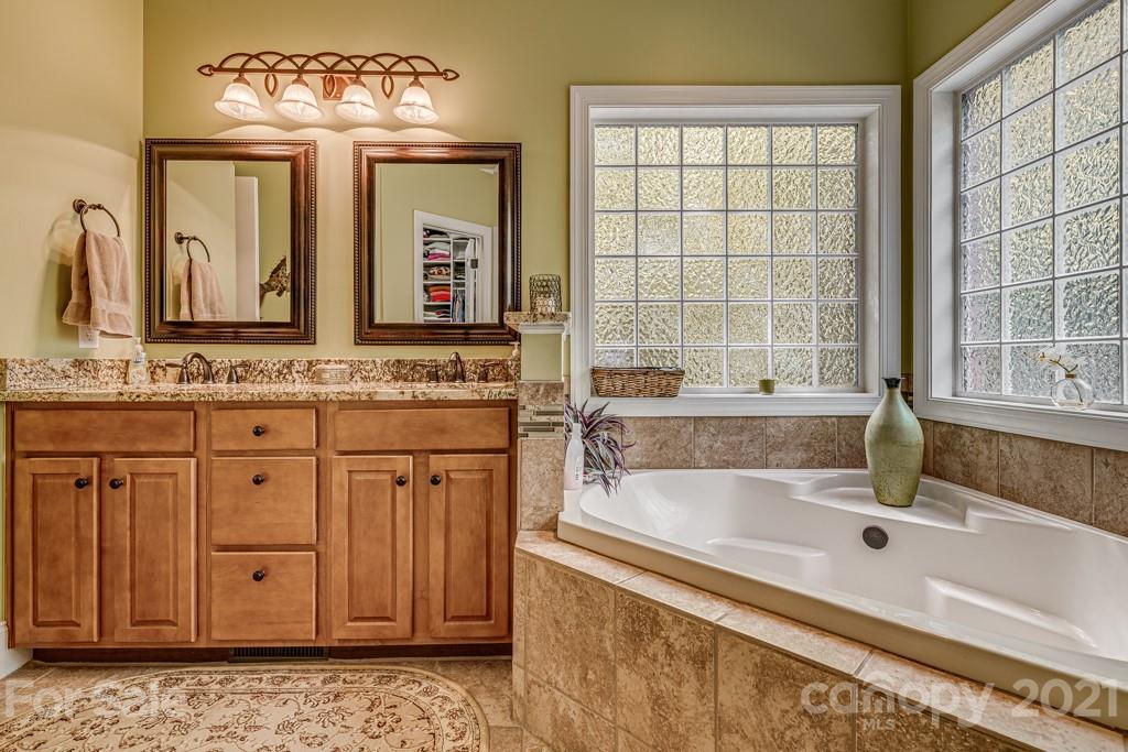4367 Lake Shore Road North Denver, NC 28037 - Photo 23 of 48 a spacious bathroom with a granite countertop tub and a large window