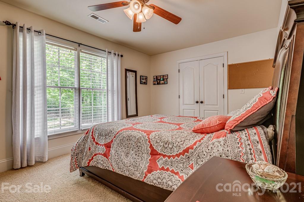 4367 Lake Shore Road North Denver, NC 28037 - Photo 28 of 48 a bed sitting in a bedroom next to a window