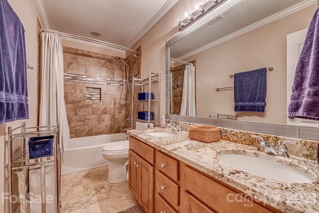 4367 Lake Shore Road North Denver, NC 28037 - Photo 36 of 48 a bathroom with a granite countertop sink toilet mirror and bathtub